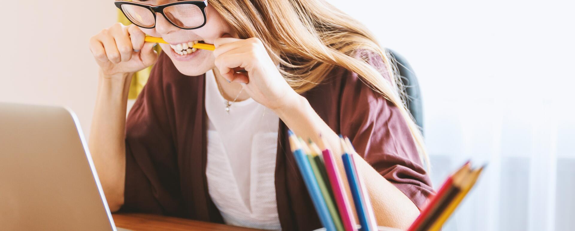 frustrated junior drupal developer biting a pencil after making a mistake