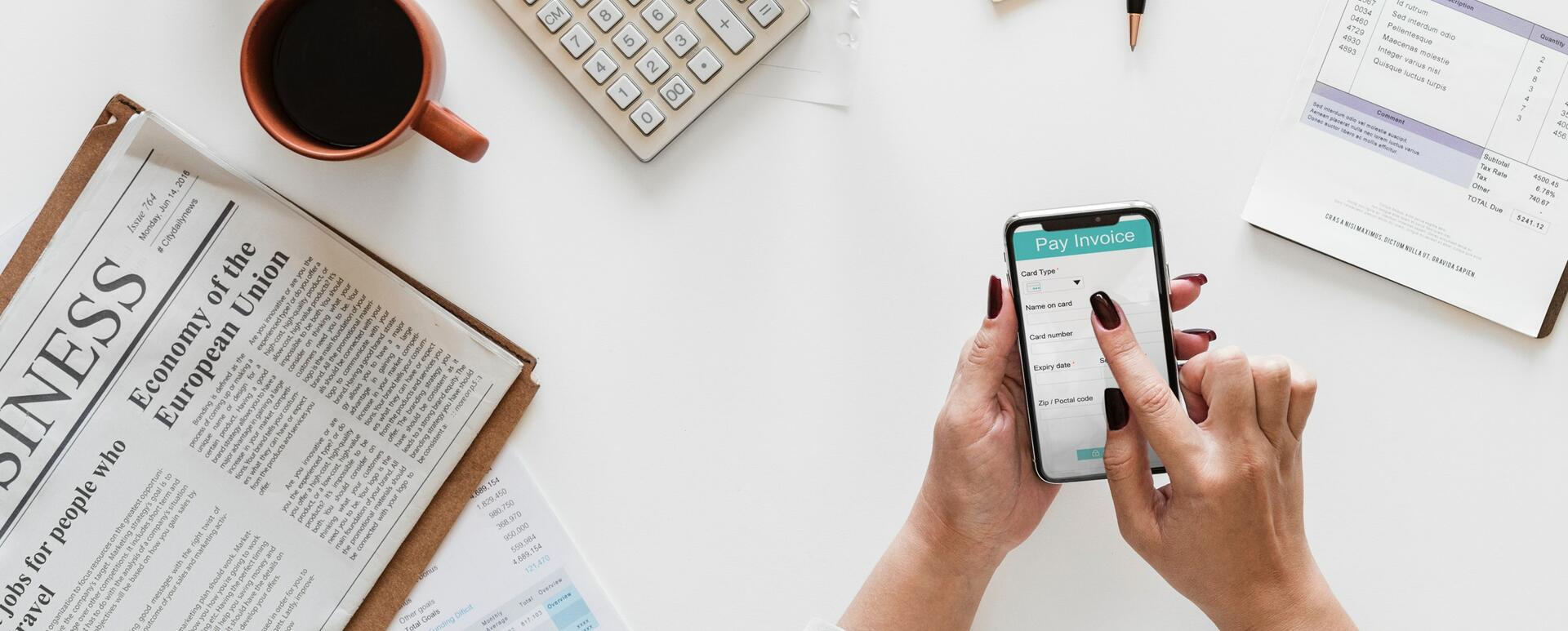 A business owner views an invoice on the mobile phone