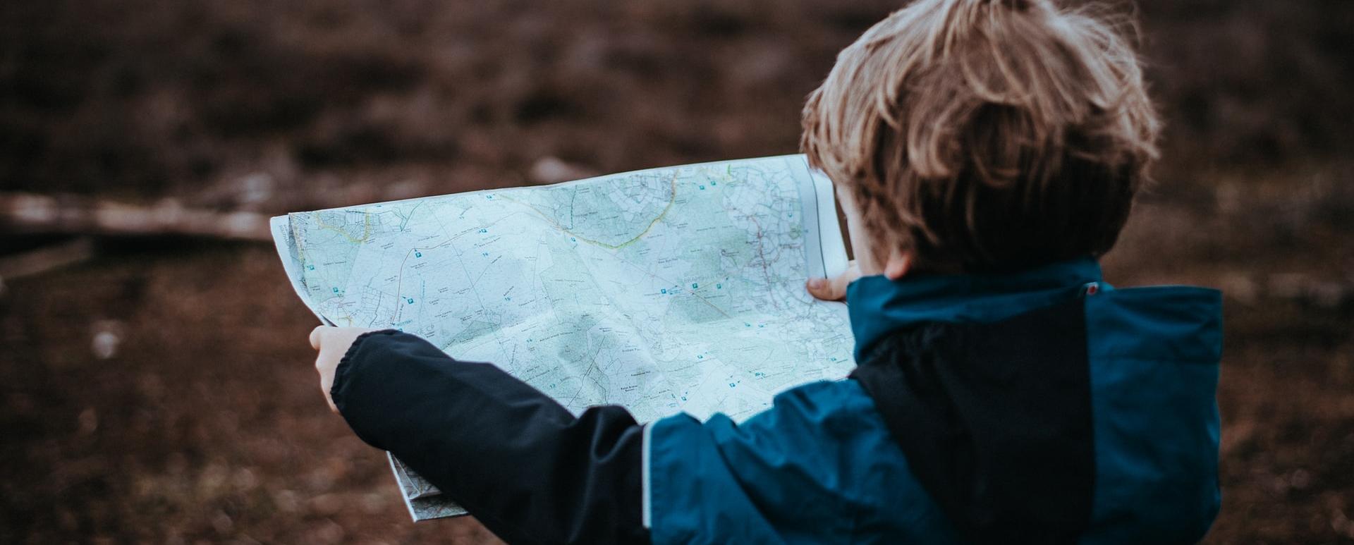 main blog post picture - a boy with a map