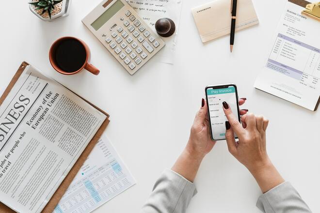 A business owner views an invoice on the mobile phone