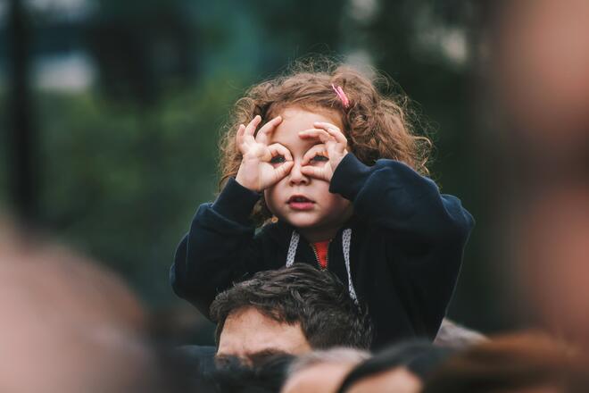 A girl making binocular gesture as in searching for something. Maybe she's looking for your drupal website in google?