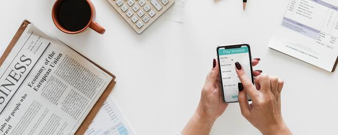 A business owner views an invoice on the mobile phone