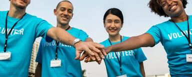 A team of people holding hands together